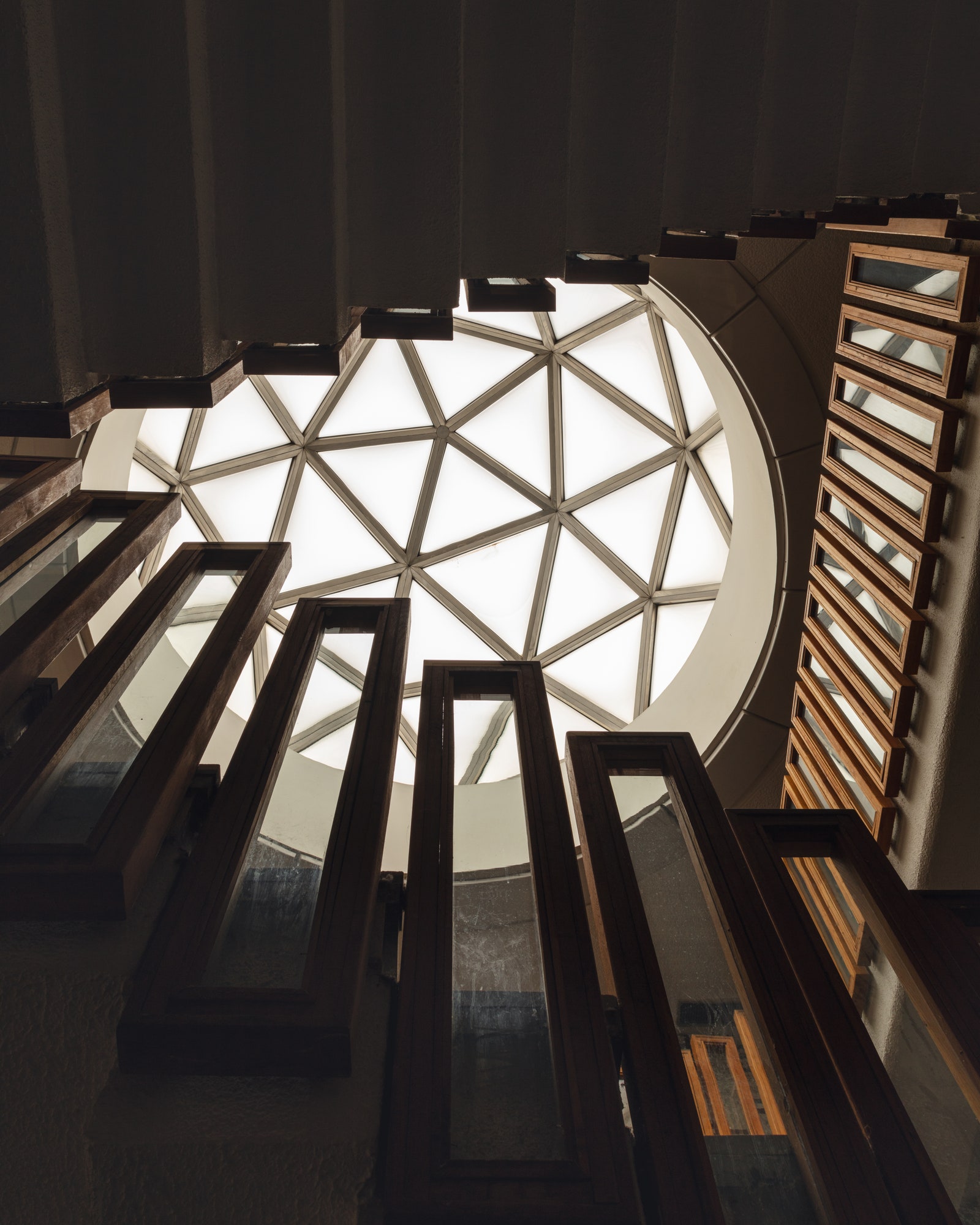 One of the 74 domes modelled on Richard Buckminster Fullers geodesic ones silhouettes the oak stairway rails. These...