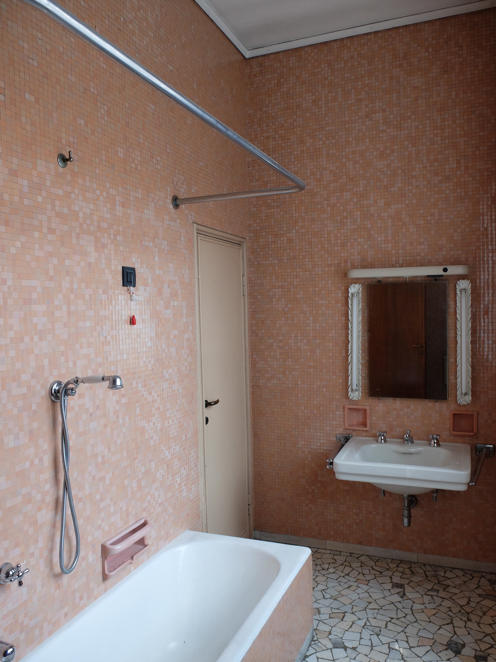A tiled bathroom with crazy mosaic floor