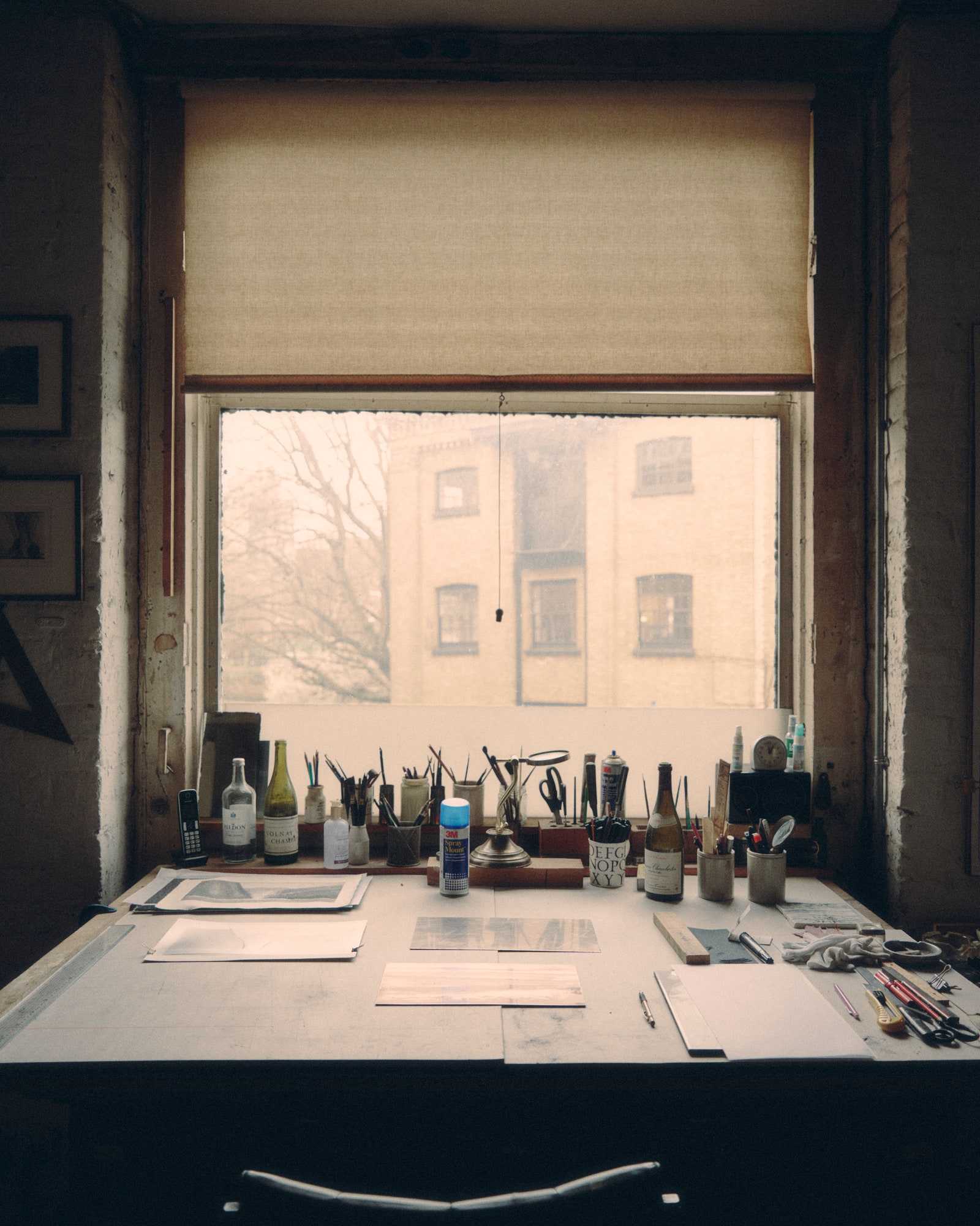Norman Ackroyd studio. Cup Desk Furniture Table Art Painting Window Windowsill and Pen
